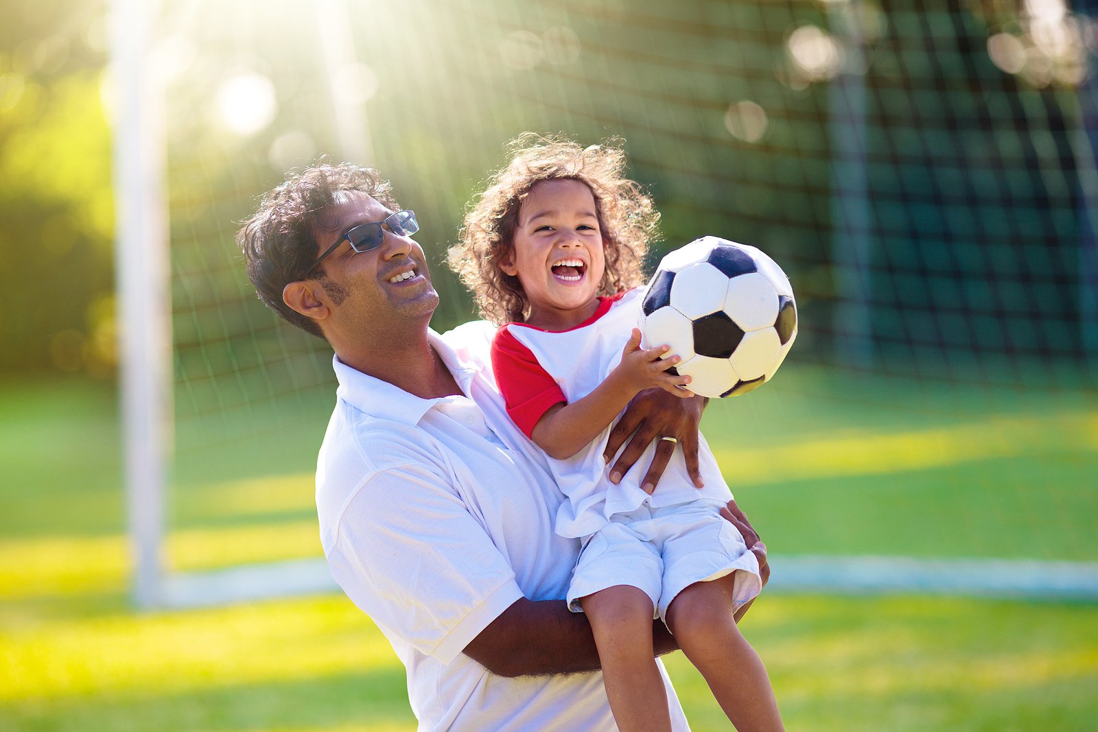 bigstock-Father-And-Son-Play-Football--458277033
